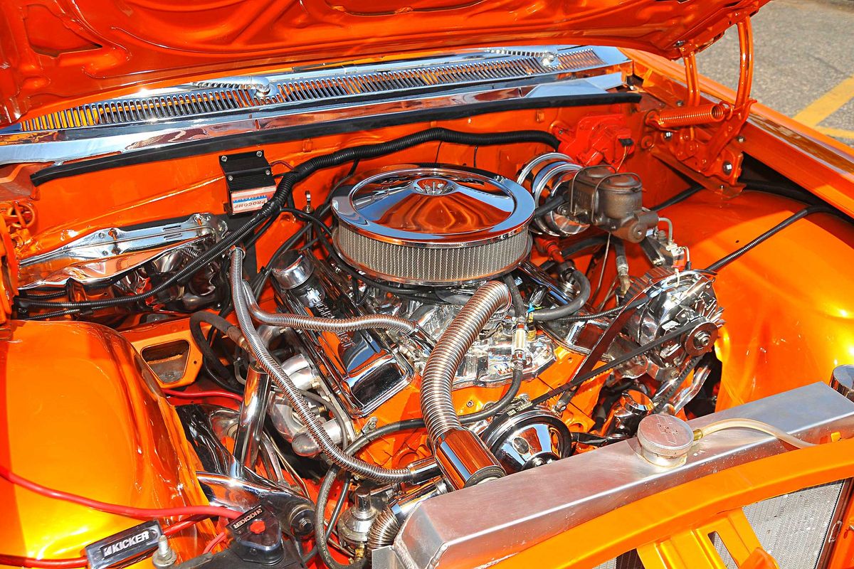 chevy impala hood open showing newly repaired engine by used auto parts from BackToRoad auto