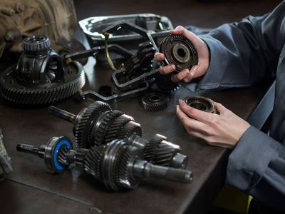 female-mechanic-holding-spare-parts-car